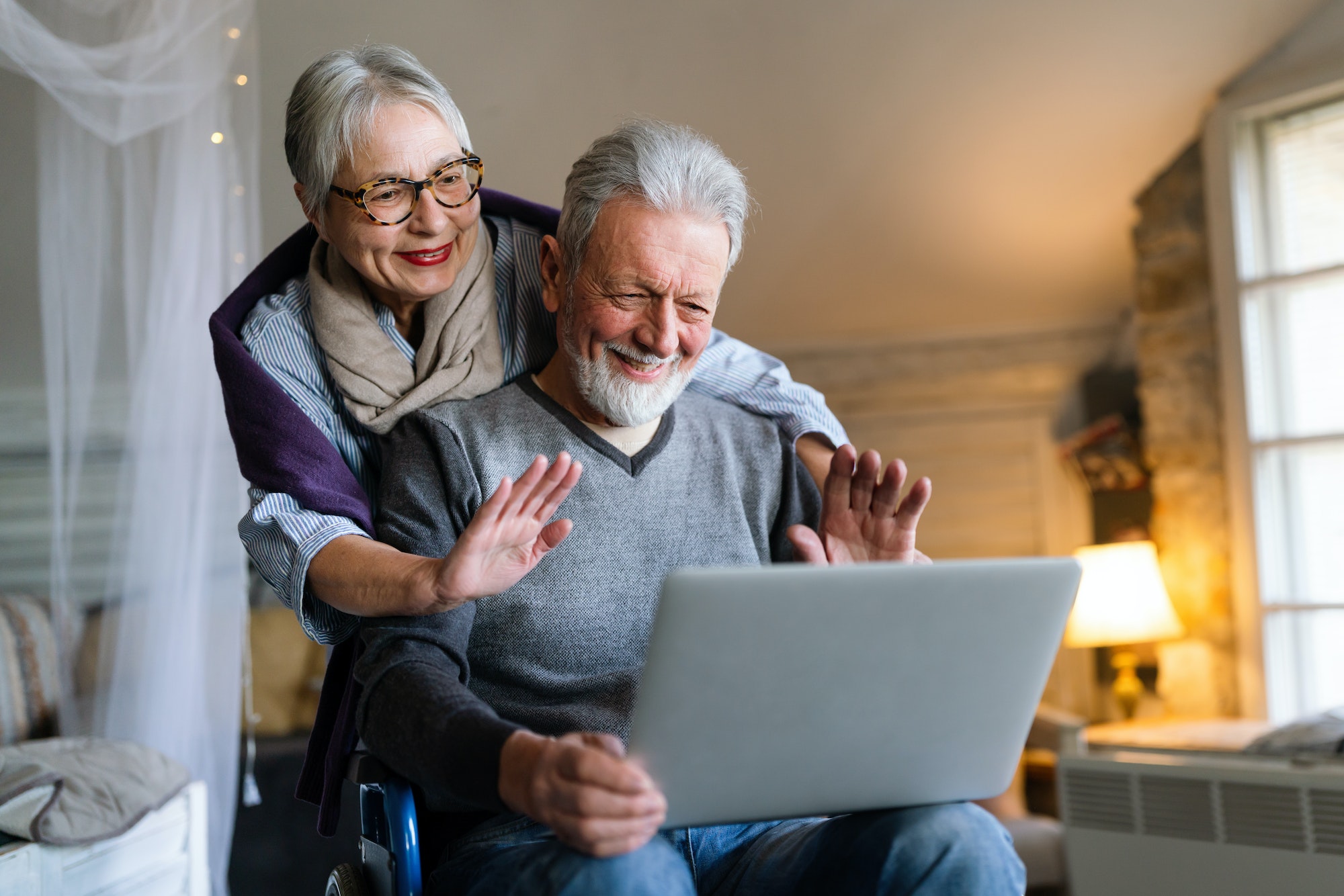 Happy romantic senior couple hugging and enjoying retirement at home